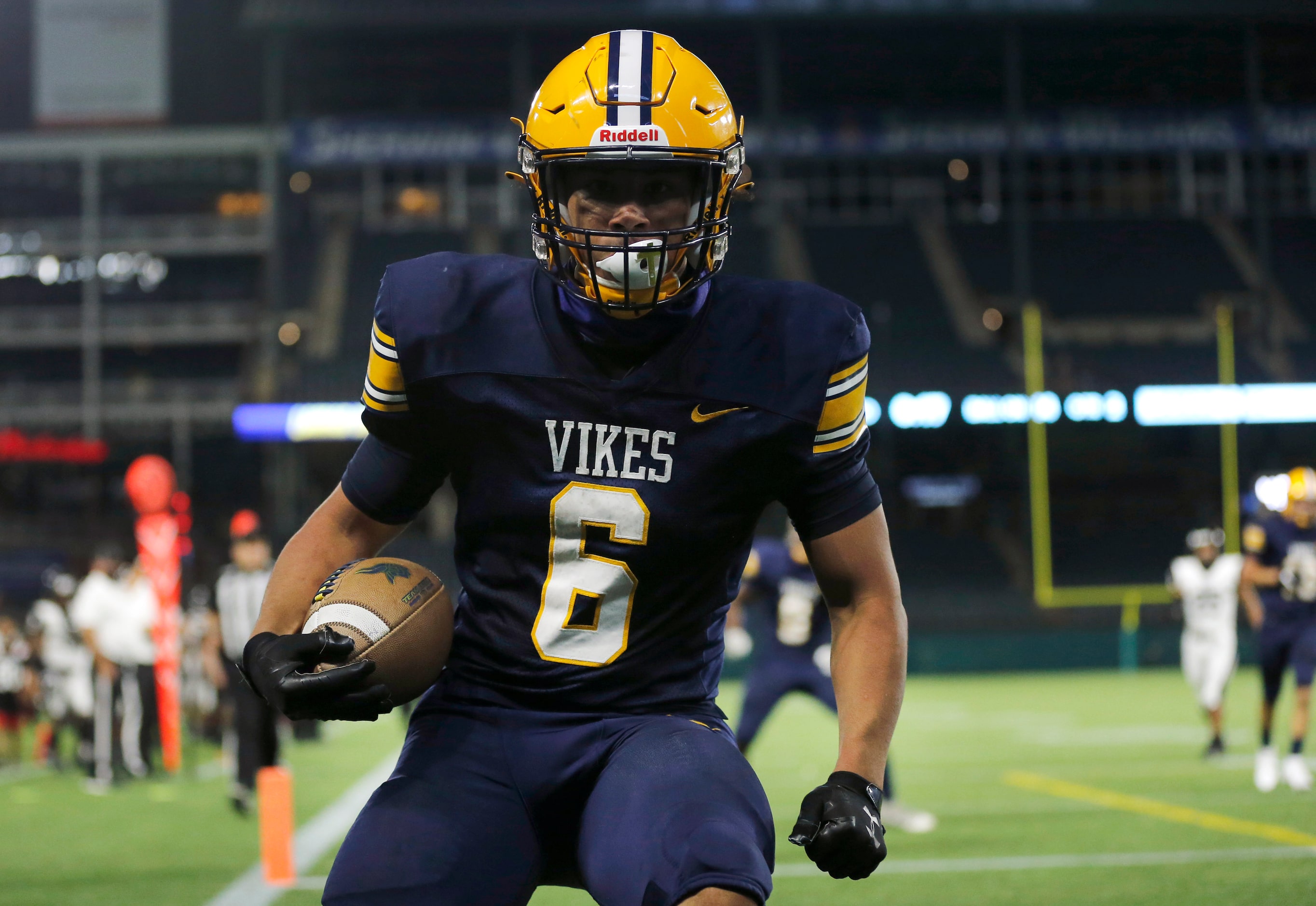 Arlington Lamar running back Anthony Williams runs up to a photographers lens after scoring...