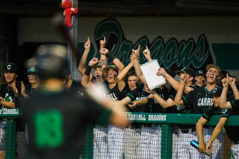 Southlake Carroll players cheer as Grant Golomb (18) steps up to bat during the third inning...