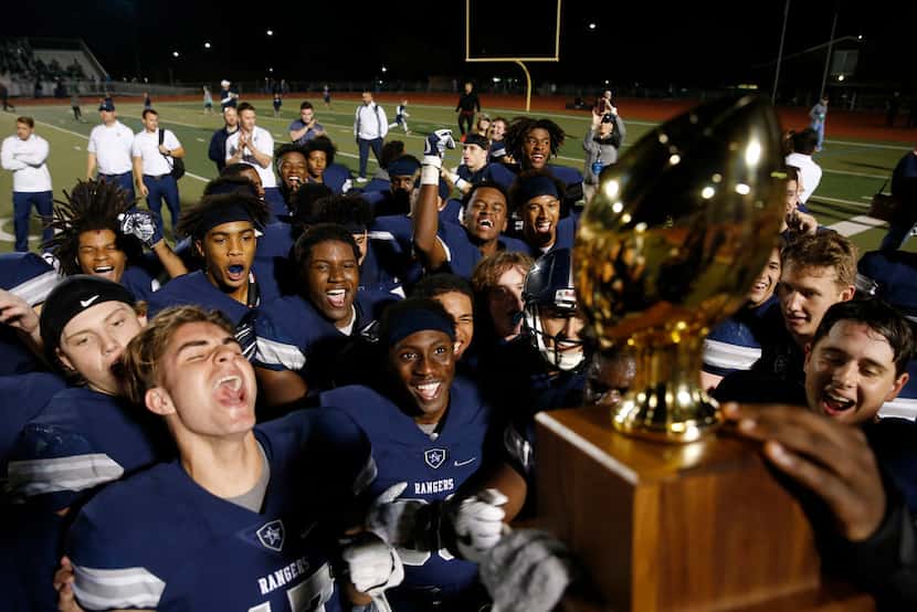 Frisco Lone Star celebrates as they receive the 13-5A district trophy after defeating Frisco...