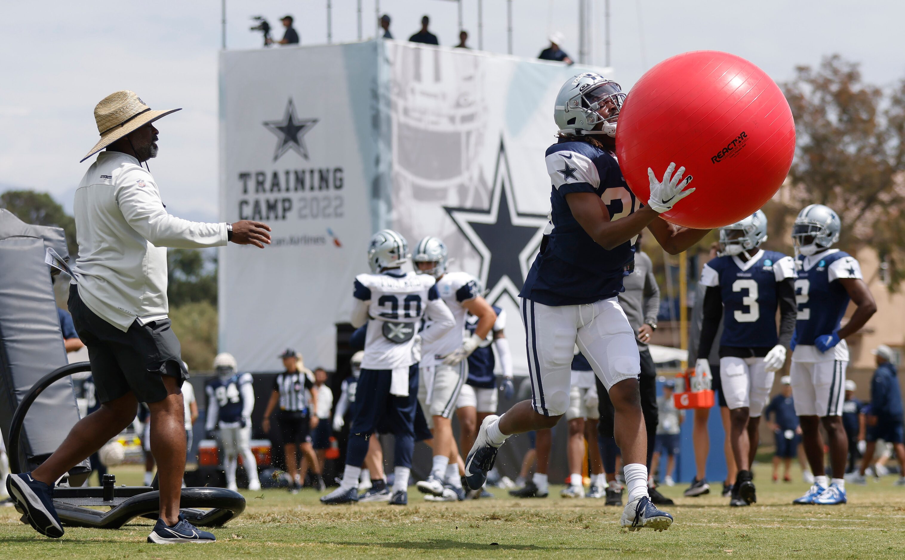 Dallas Cowboys cornerback Isaac Taylor-Stuart (36) catches a red exercise ball after pushing...