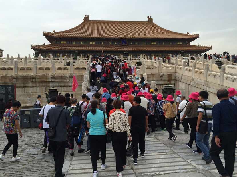 Long lines of tourists stream into one of the buildings at the Forbidden City in Beijing,...