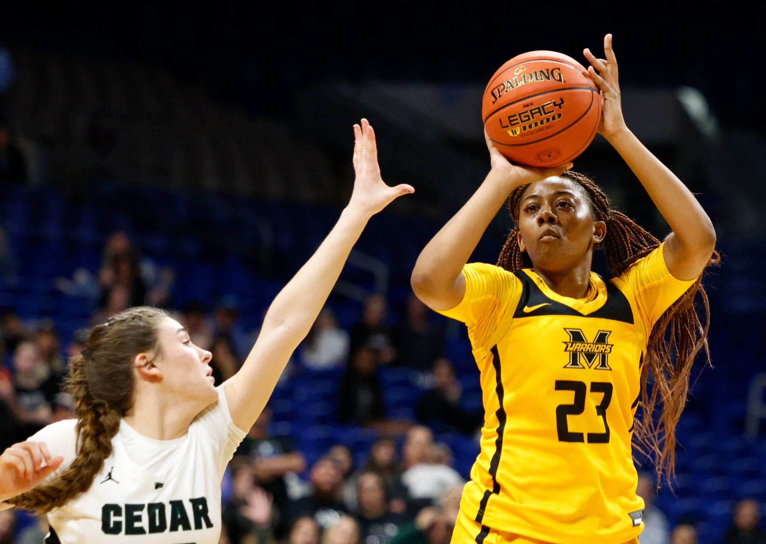 Frisco Memorial guard Jordan Conerly (23) launches a shot over Cedar Park guard Megan Woods...