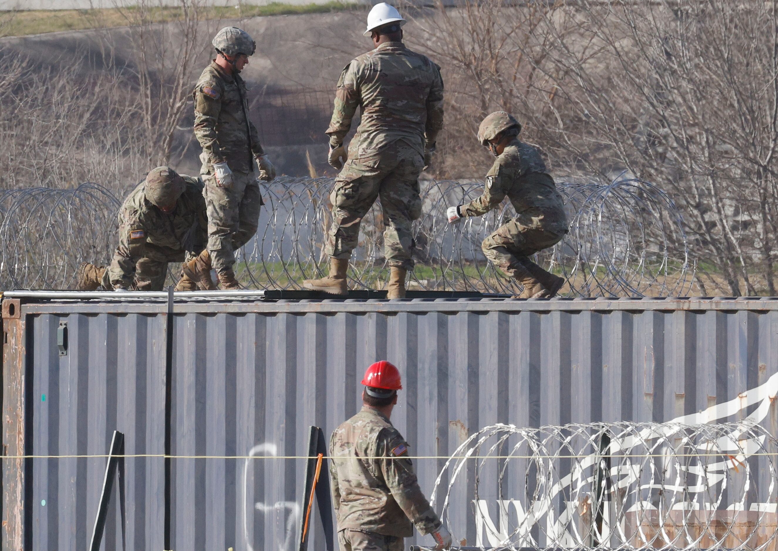 National Guard soldiers install razor wire near Shelby Park, Wednesday, Jan. 31, 2024, in...