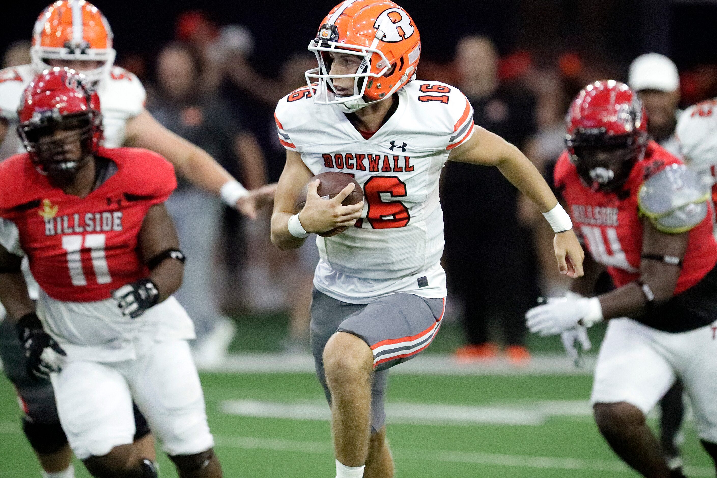 Rockwall High School quarterback Mason Marshall (16) carries the ball during the first half...