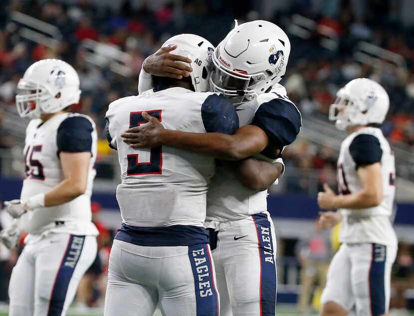 Allen running back Brock Sturges (5) is congratulated by quarterback Grant Tisdale (14)...