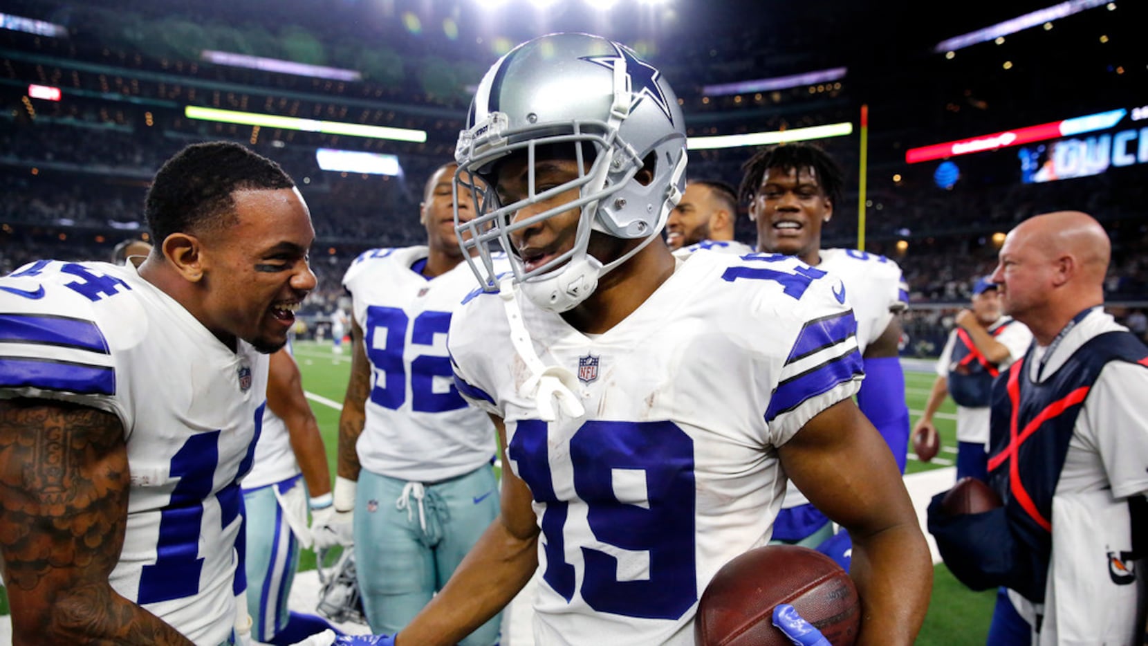 Dallas Cowboys wide receiver Amari Cooper (19) is congratulated on the sideline by fellow...