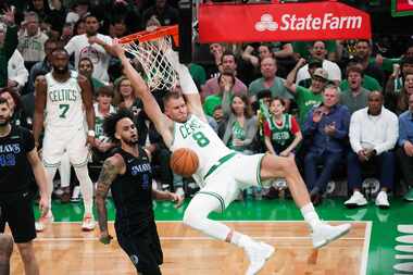 Boston Celtics center Kristaps Porzingis (8) dunks the ball past Dallas Mavericks center...