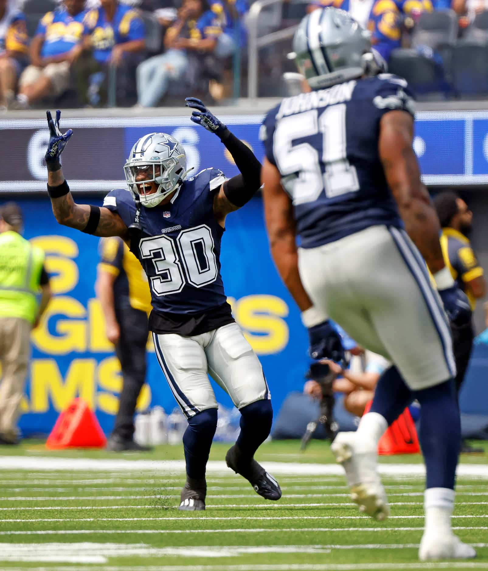 Dallas Cowboys safety Juanyeh Thomas (30) reacts to letting an interception slip past his...