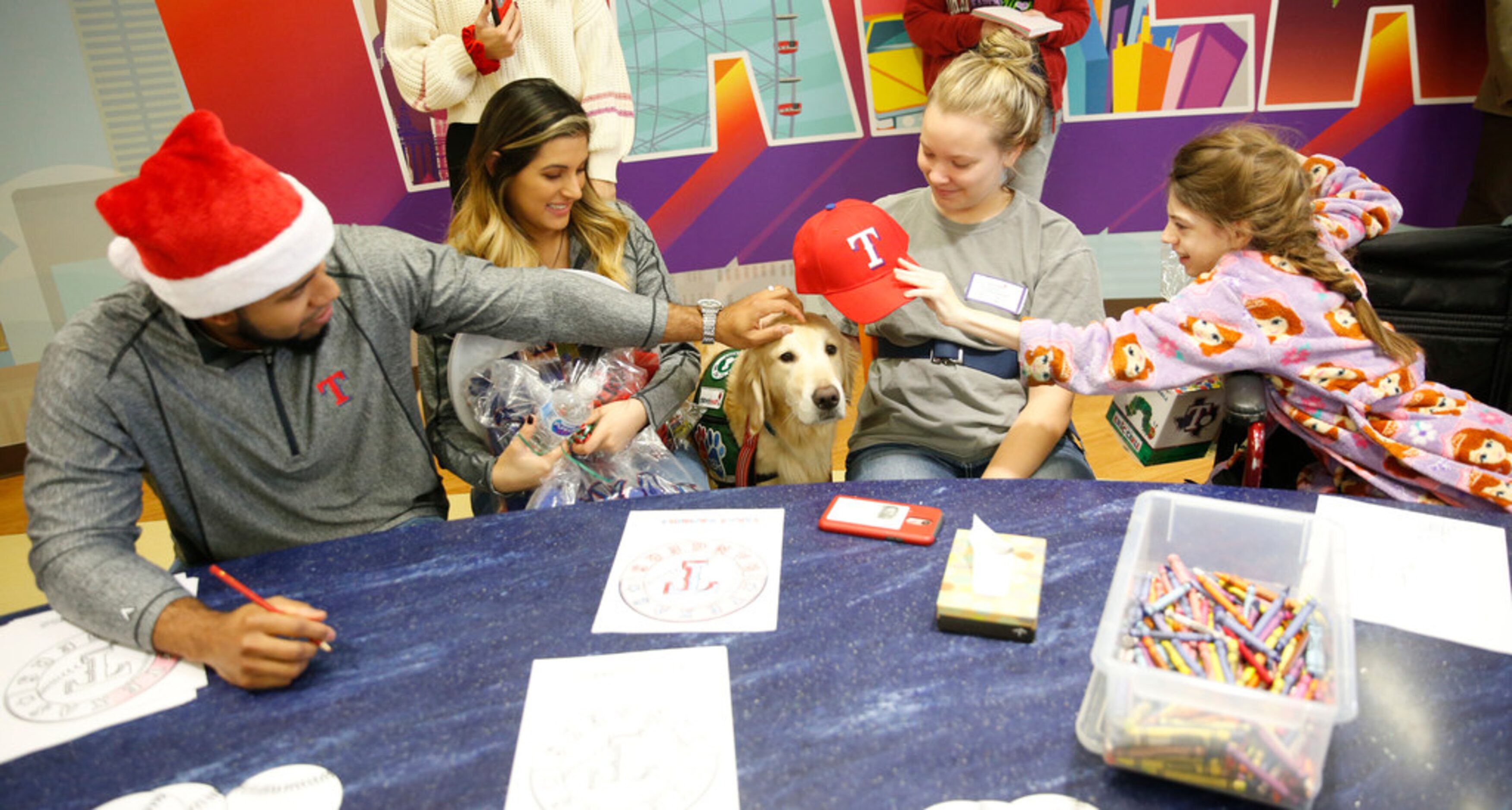 Texas Rangers shortstop Elvis Andrus (from left) and his wife, Cori Andrus put a Rangers hat...