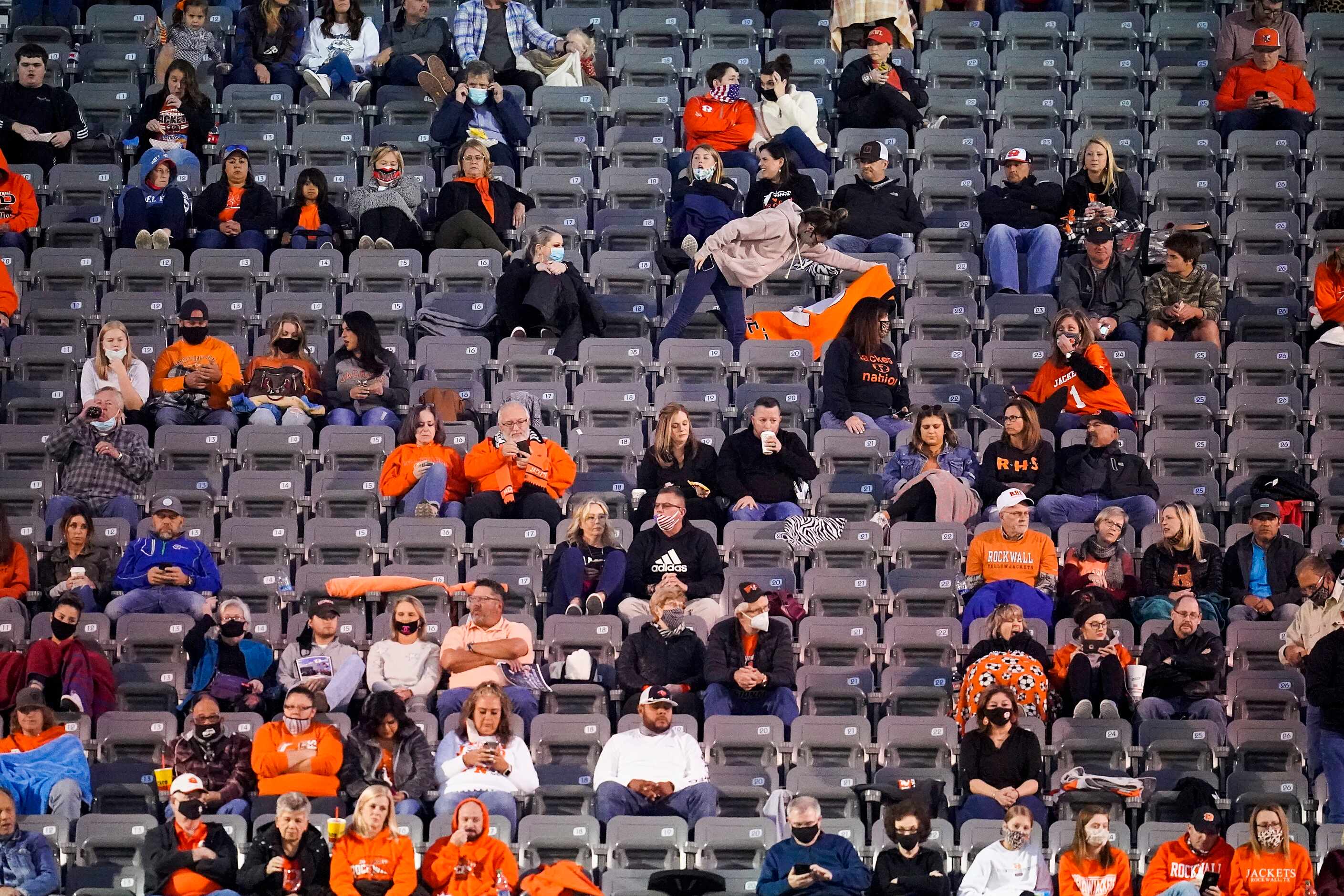 Socially distant Rockwall fans take their seats before a high school football game against...