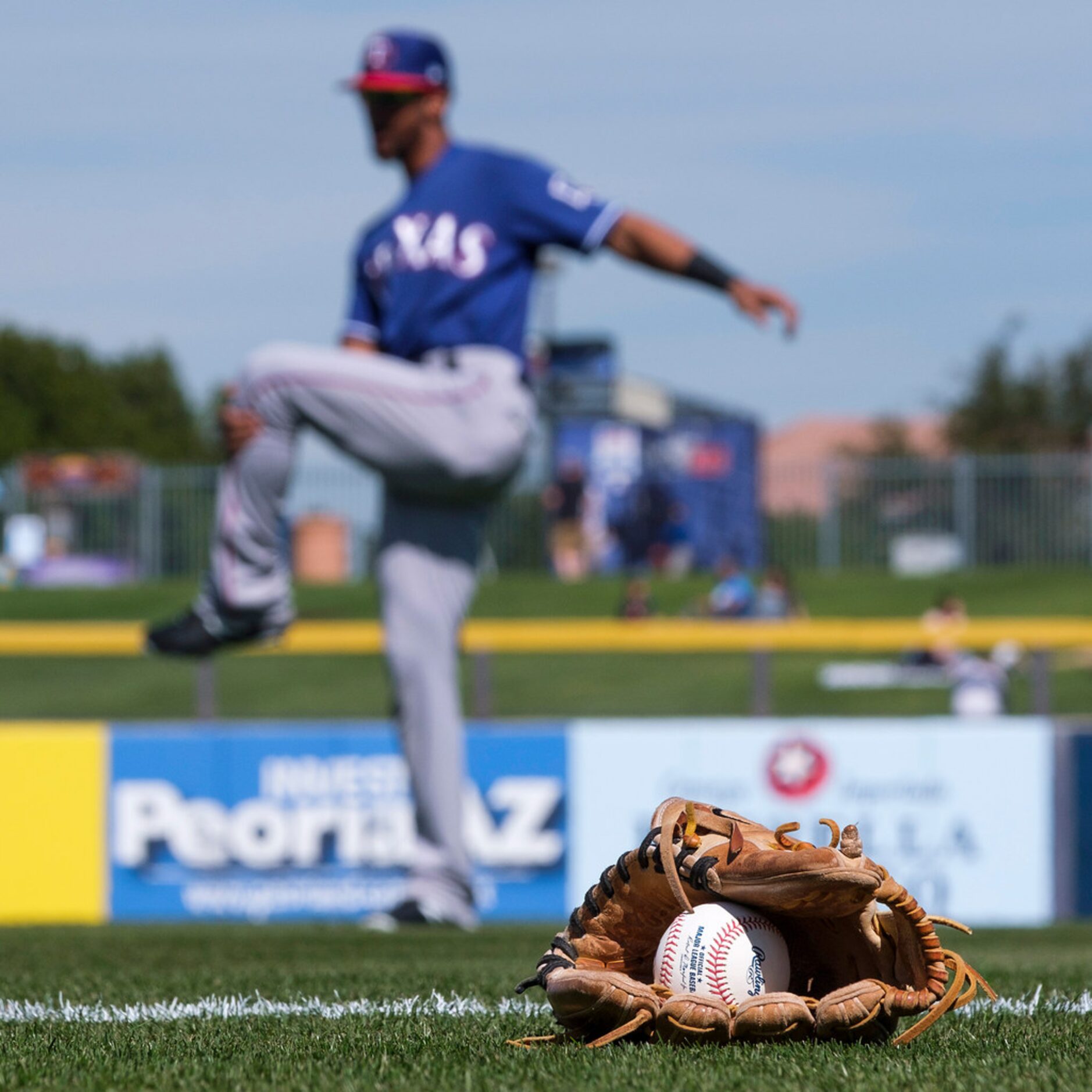 Texas Rangers outfielder Leody Taveras stretches before a spring training baseball game...