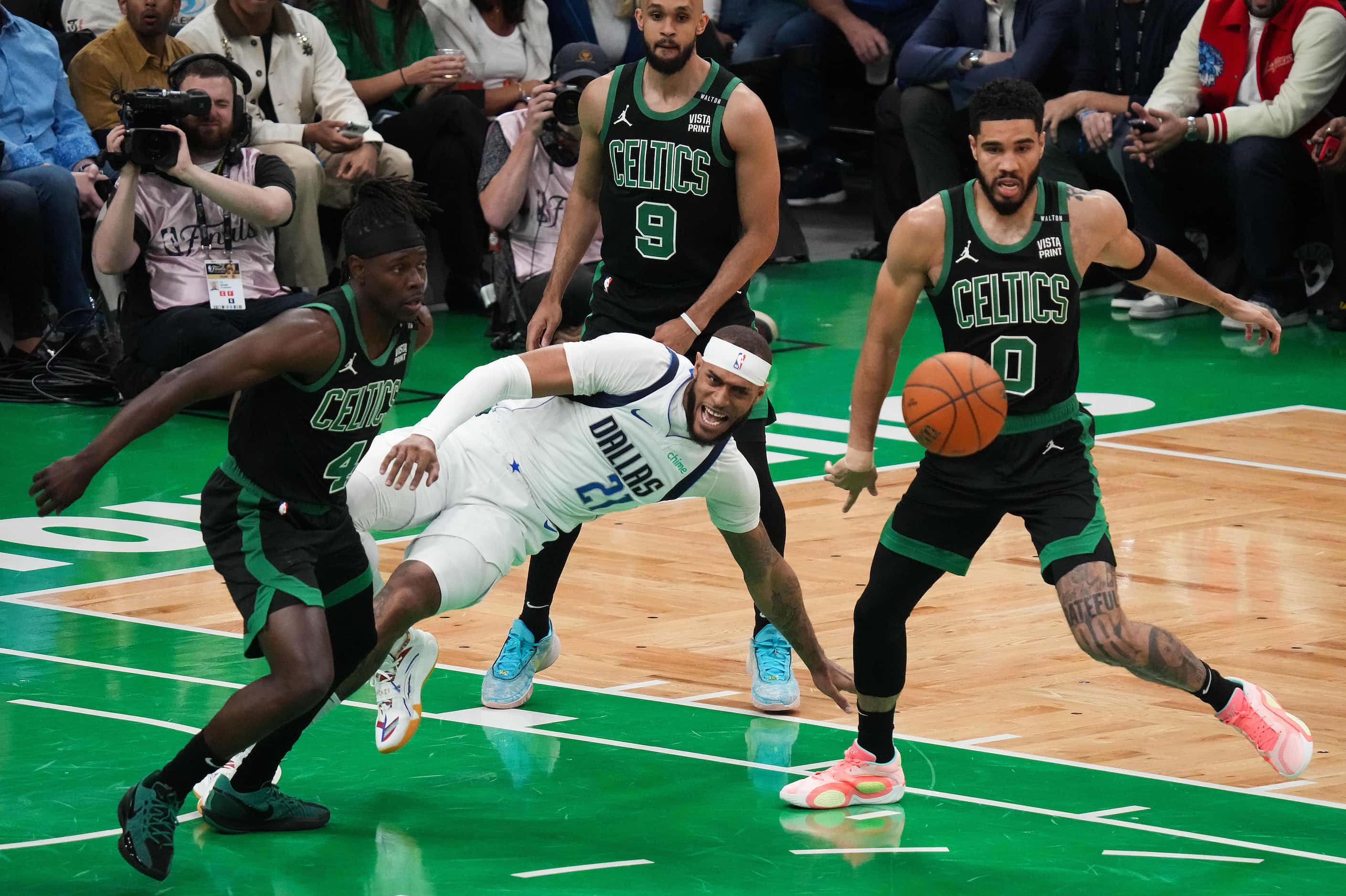 Dallas Mavericks center Daniel Gafford (21) turns the ball over as Boston Celtics guard Jrue...