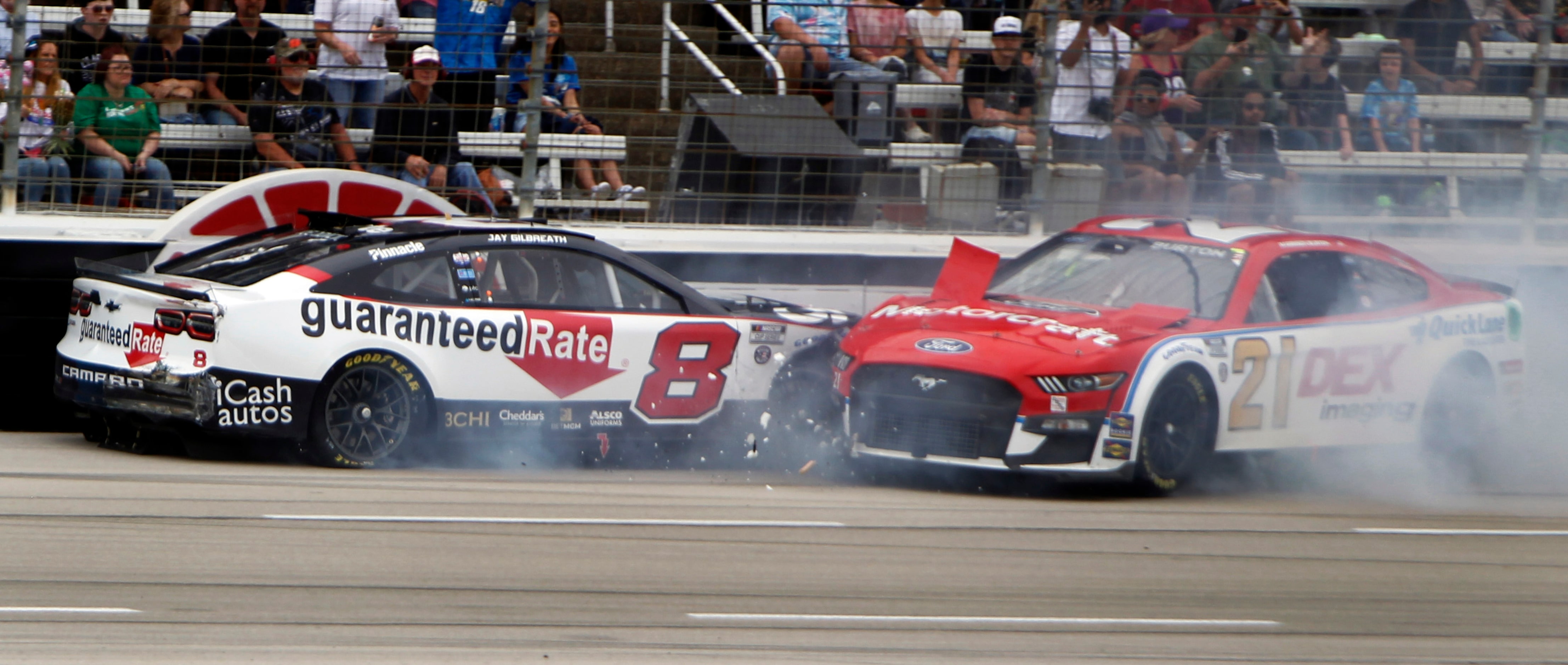 Driver Tyler Reddick, left, in the #8 Guaranteed Rate Chevrolet began spinning out of...