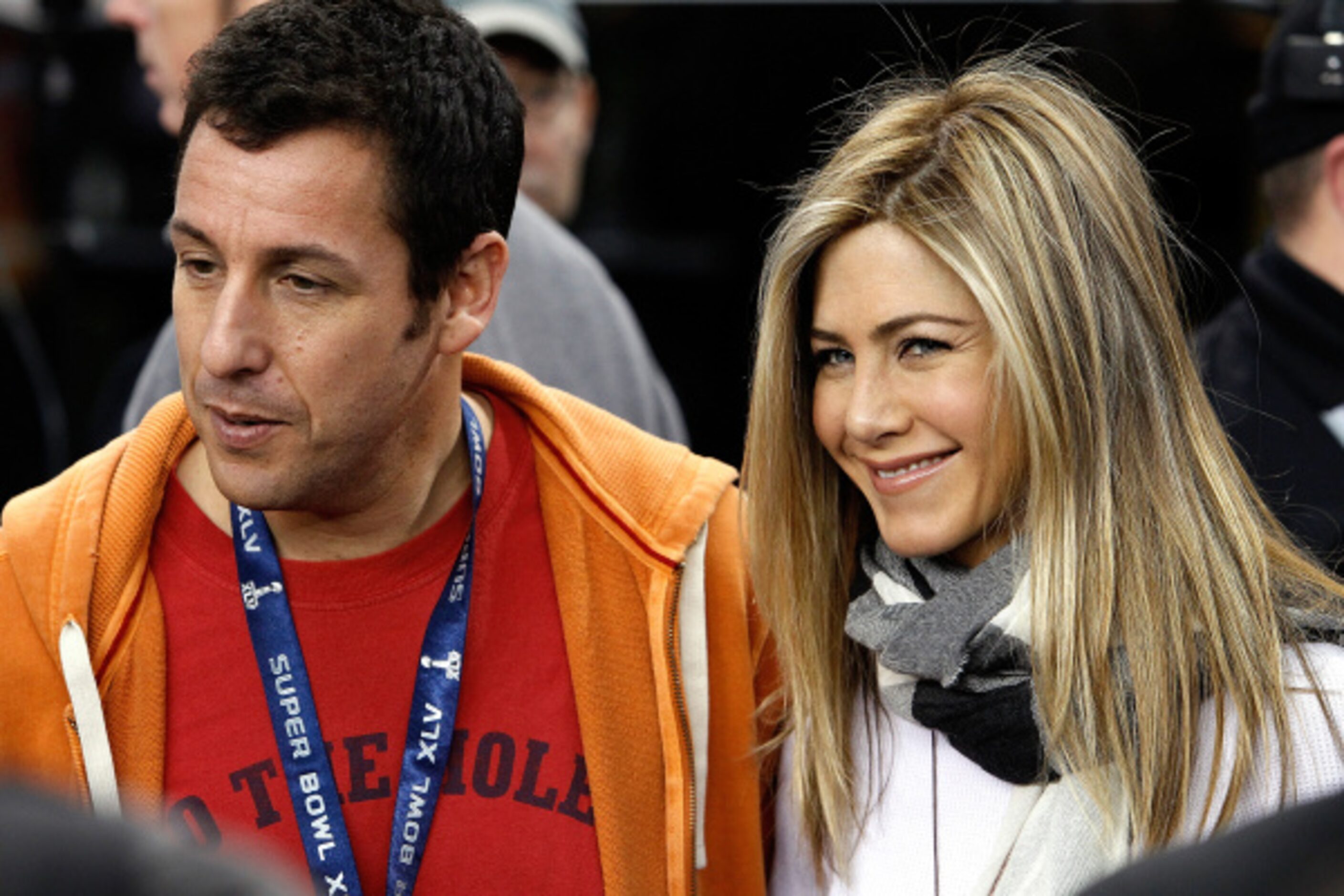 Celebrities Jennifer Aniston, right, and Adam Sandler appear together before Super Bowl XLV...