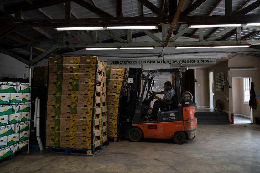 Lucio Ramirez, 53, moves jackfruit pallets into the Border Missions warehouse in Hidalgo....