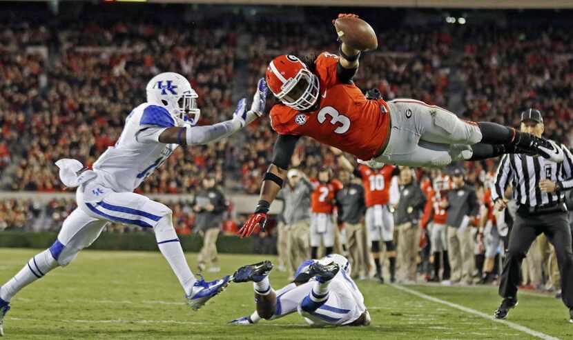 In this Nov. 23, 2013, file photo, Georgia running back Todd Gurley (3) dives into the end...