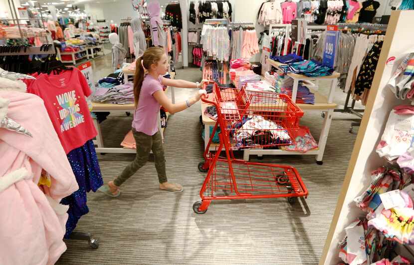 Brianna Foster, 9 of Lucas pushes the cart as she shopped in July for her back to school...