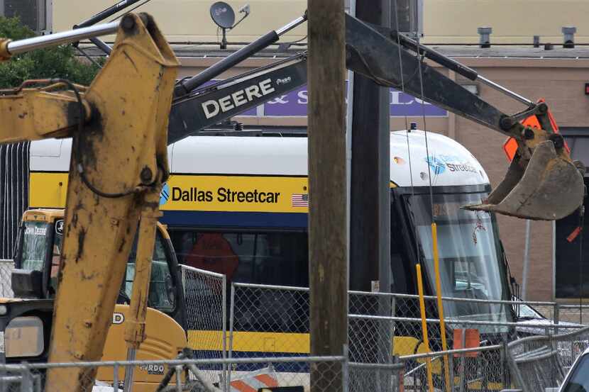 The Dallas streetcar is seen through a maze of construction at the Bishop Arts stop,...