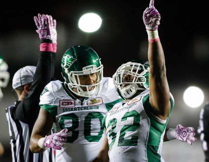 Saskatchewan Roughriders' Cameron Marshall (right) celebrates a touchdown with Spencer Moore...