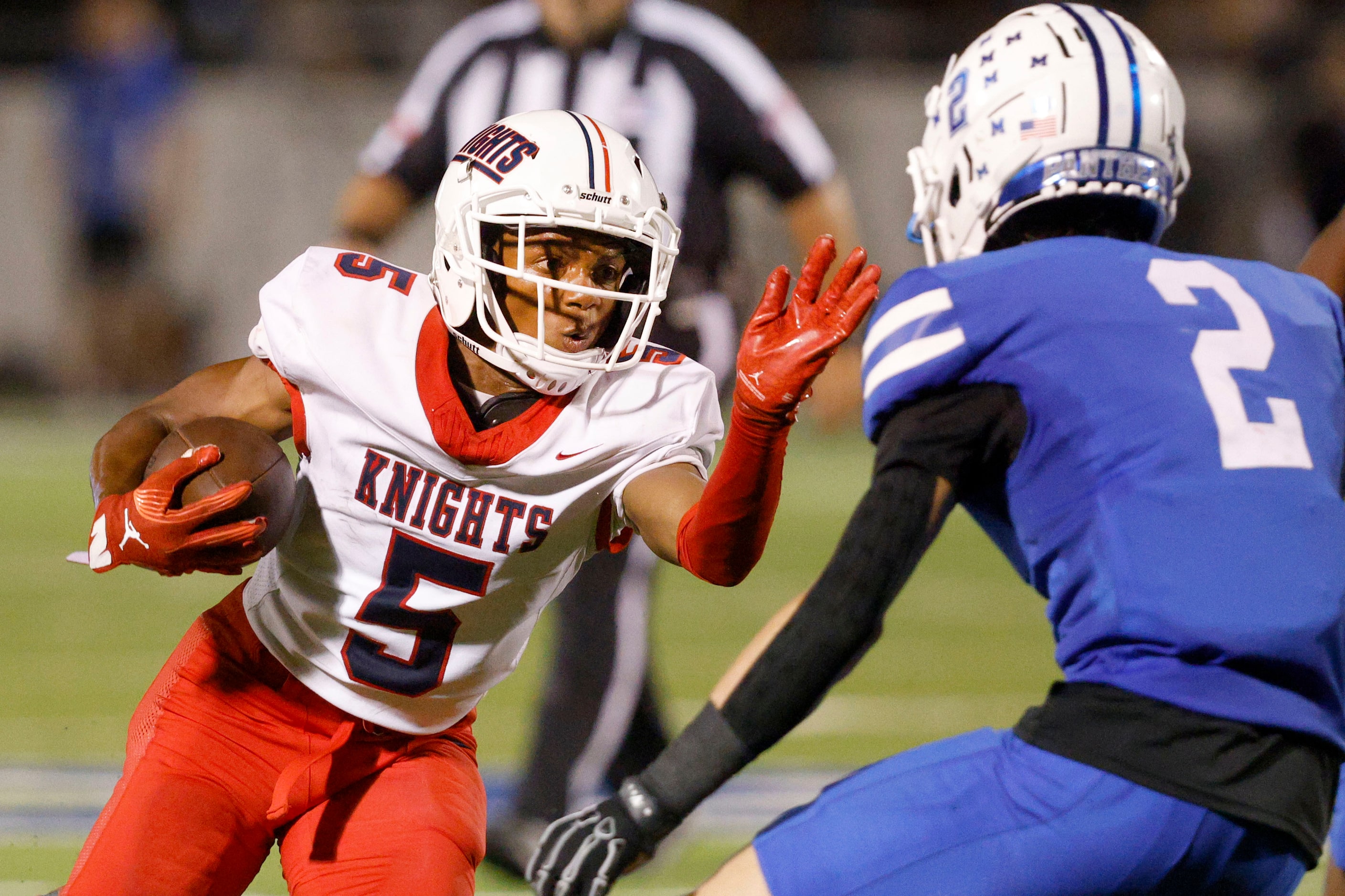 Kimball's Camrin Jackson (5) carries the ball against Midlothian's Carson Kemp (2) in the...