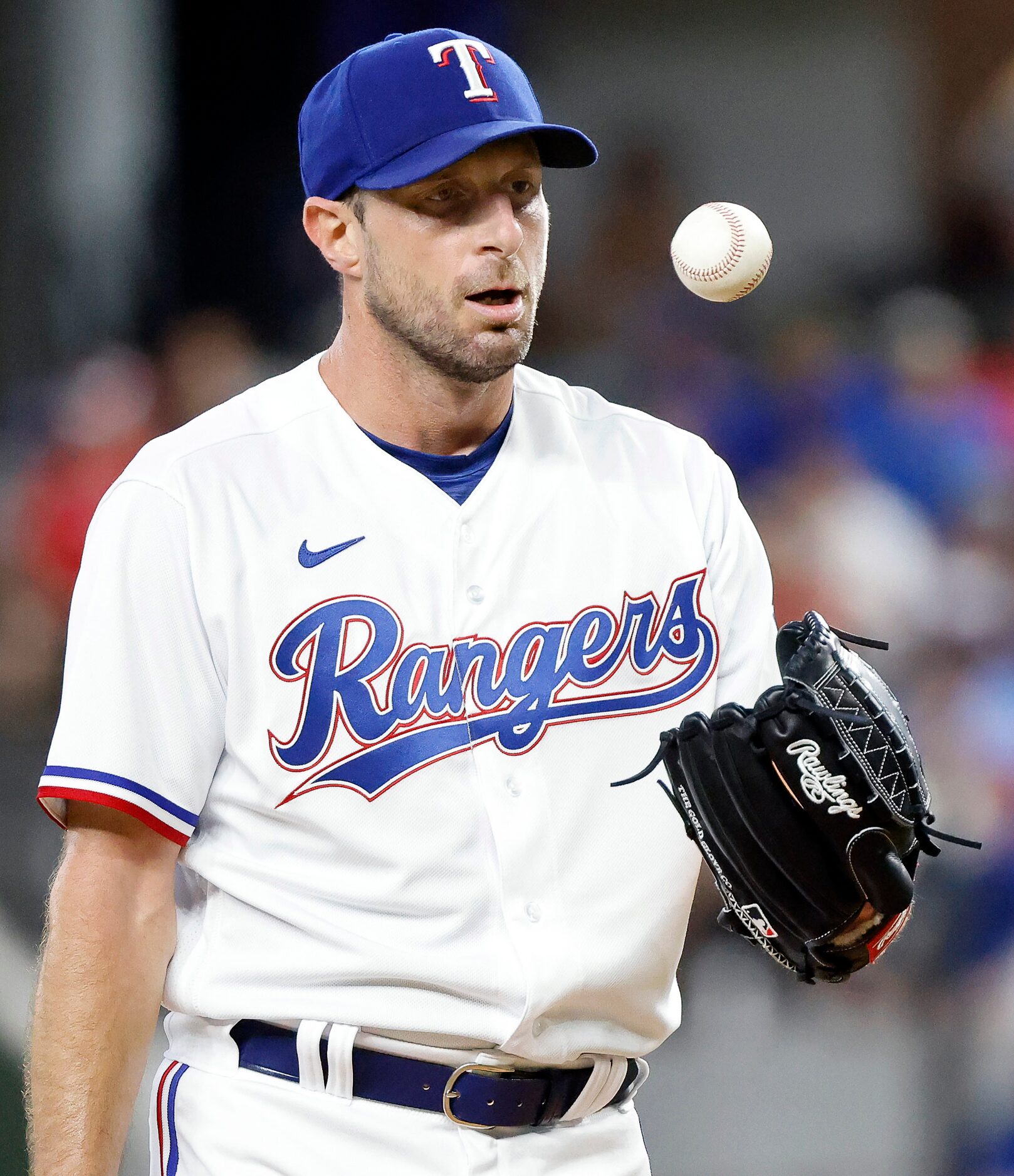 Texas Rangers starting pitcher Max Scherzer (31) tosses the ball out of his glove after...