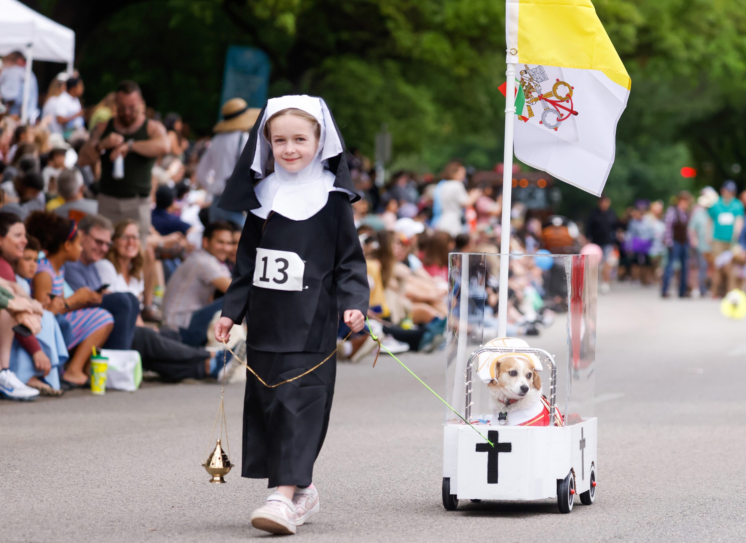 Devon Dorman (left), 8, pulls Toby Romo, a 5 year-old rescue dog with three legs, down...