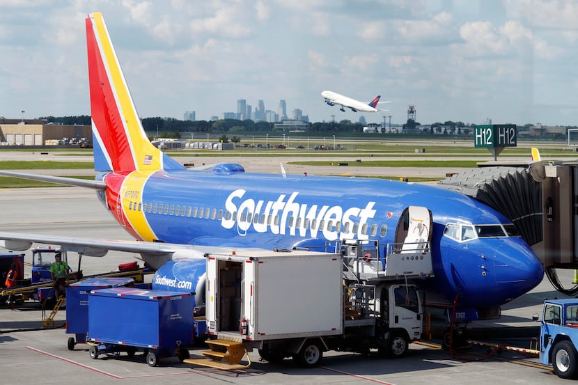 In this Tuesday, July 17, 2018, file photo ramp workers prepare a Southwest Airlines Boeing...