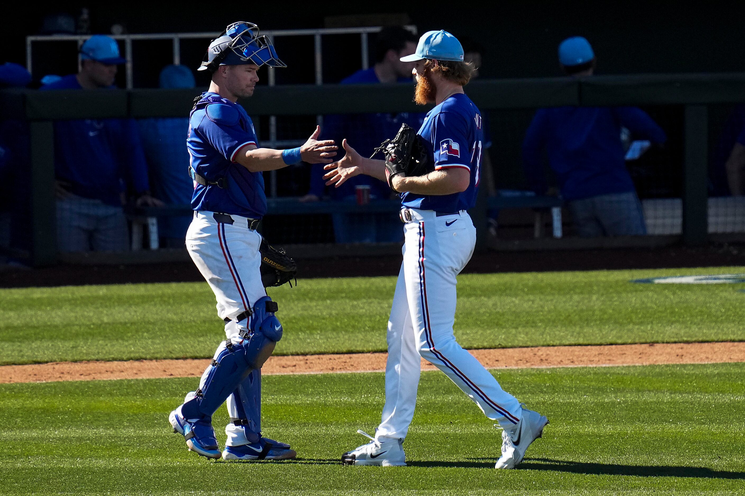 Texas Rangers pitcher Zak Kent shakes hands with catcher Andrew Knapp after the final out of...