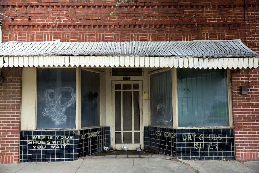 A closed cobbler's shop in the 1100 block of Singleton Boulevard shows the past commercial...