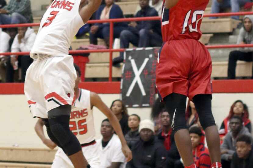 Dallas Kimball guard Odyssey Keeling (10) challenges Cedar Hill guard Ronald Pugh (3) for a...