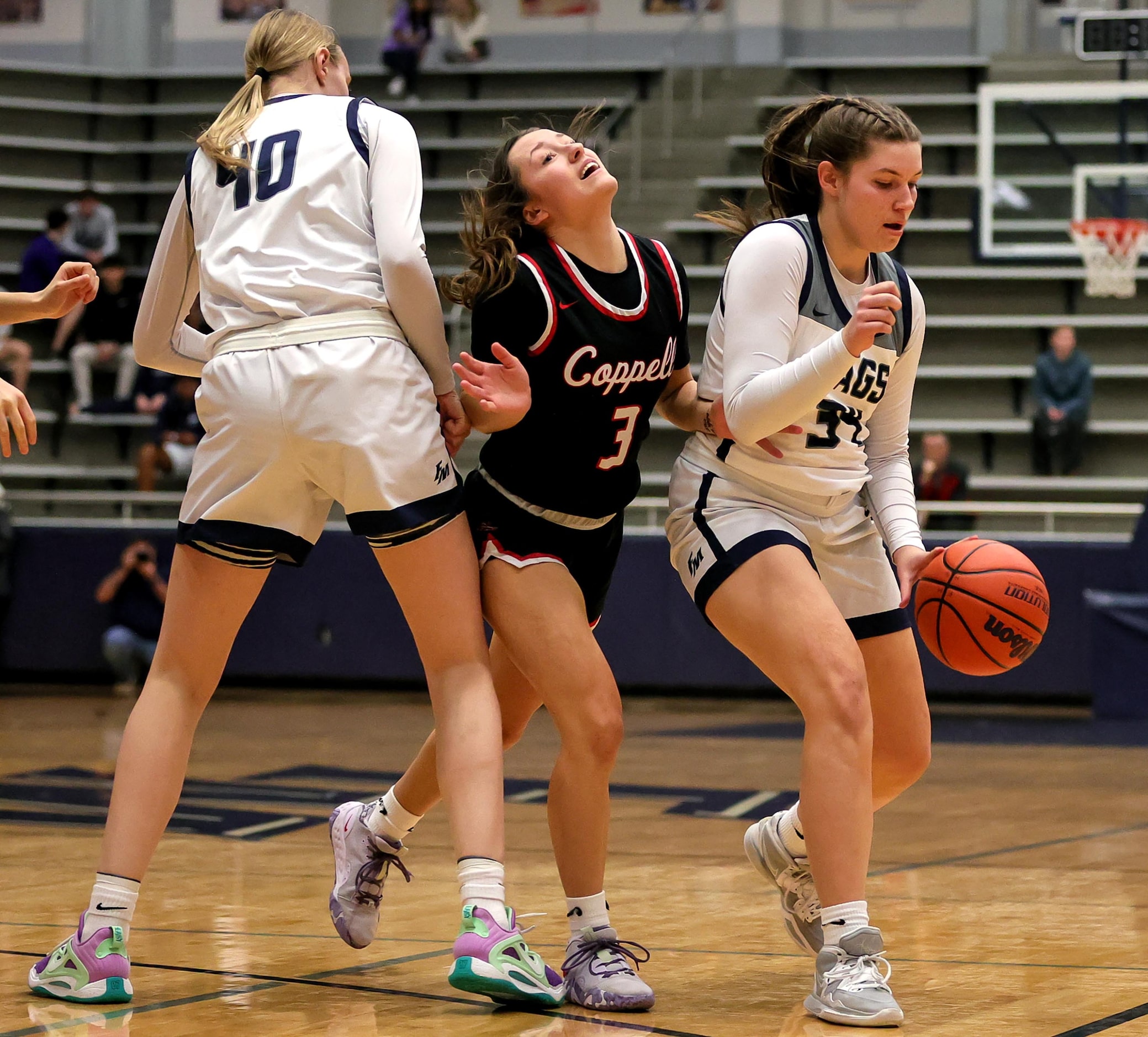 Flower Mound guard Maya Bujak (34) tries to dribble around Coppell guard Macey Mercer (3)...