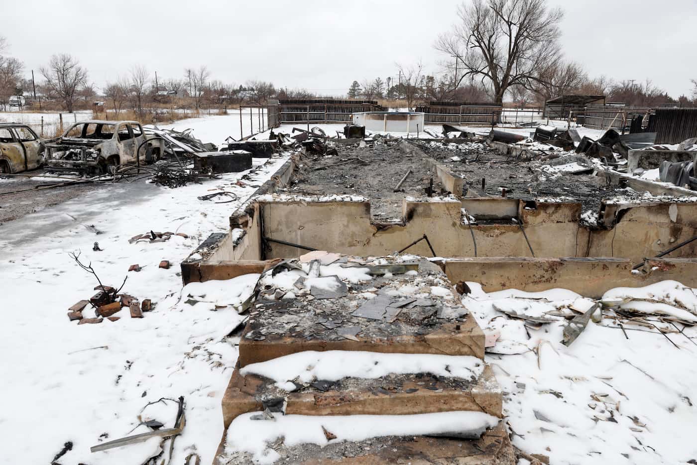 Snow covers the charred remains of a house after the Smokehouse Creek Fire, Thursday, Feb....