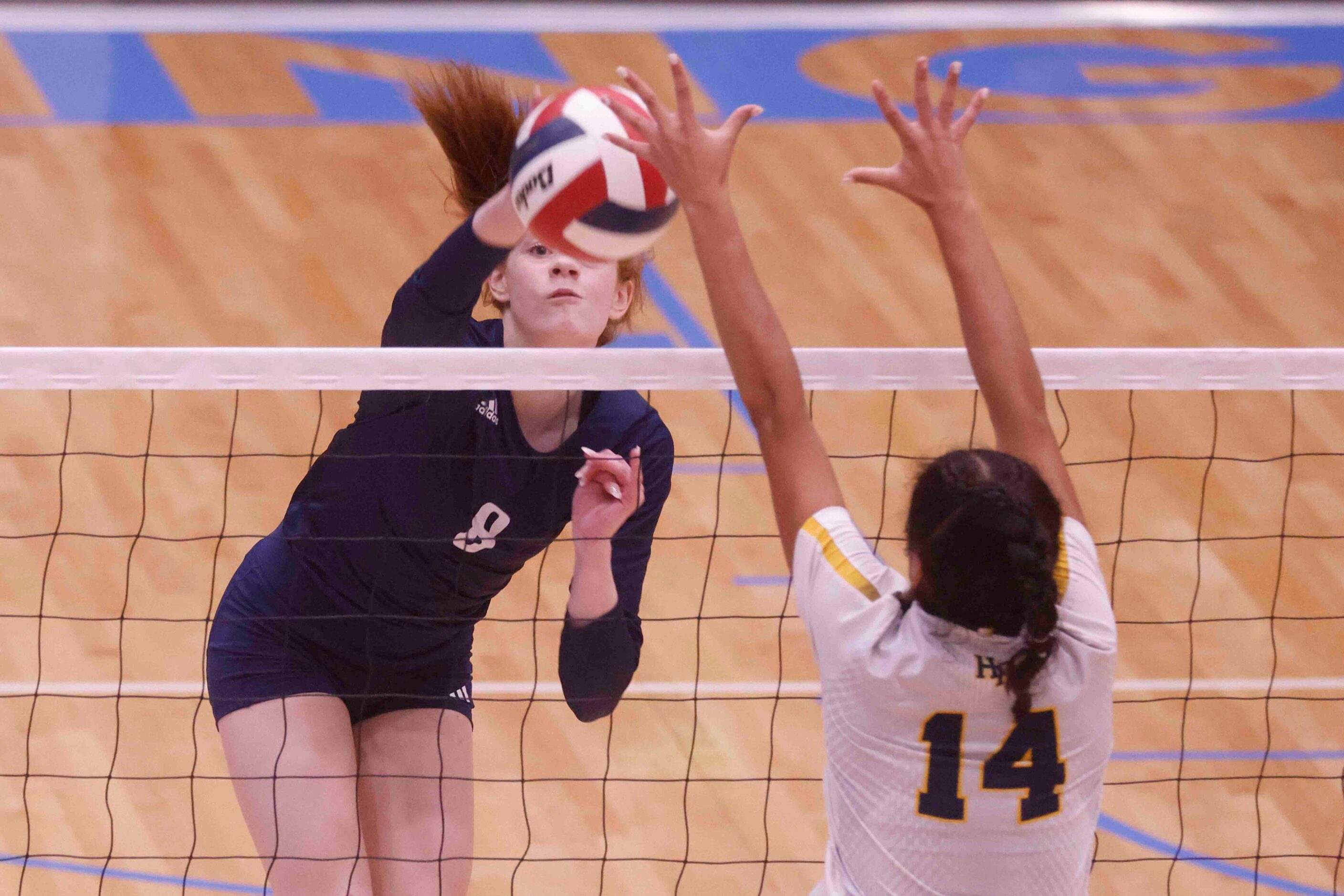 Flower Mound’s Ava Ciccarello (8) spikes the ball against Highland Park’s Bella Ocampo (14)...