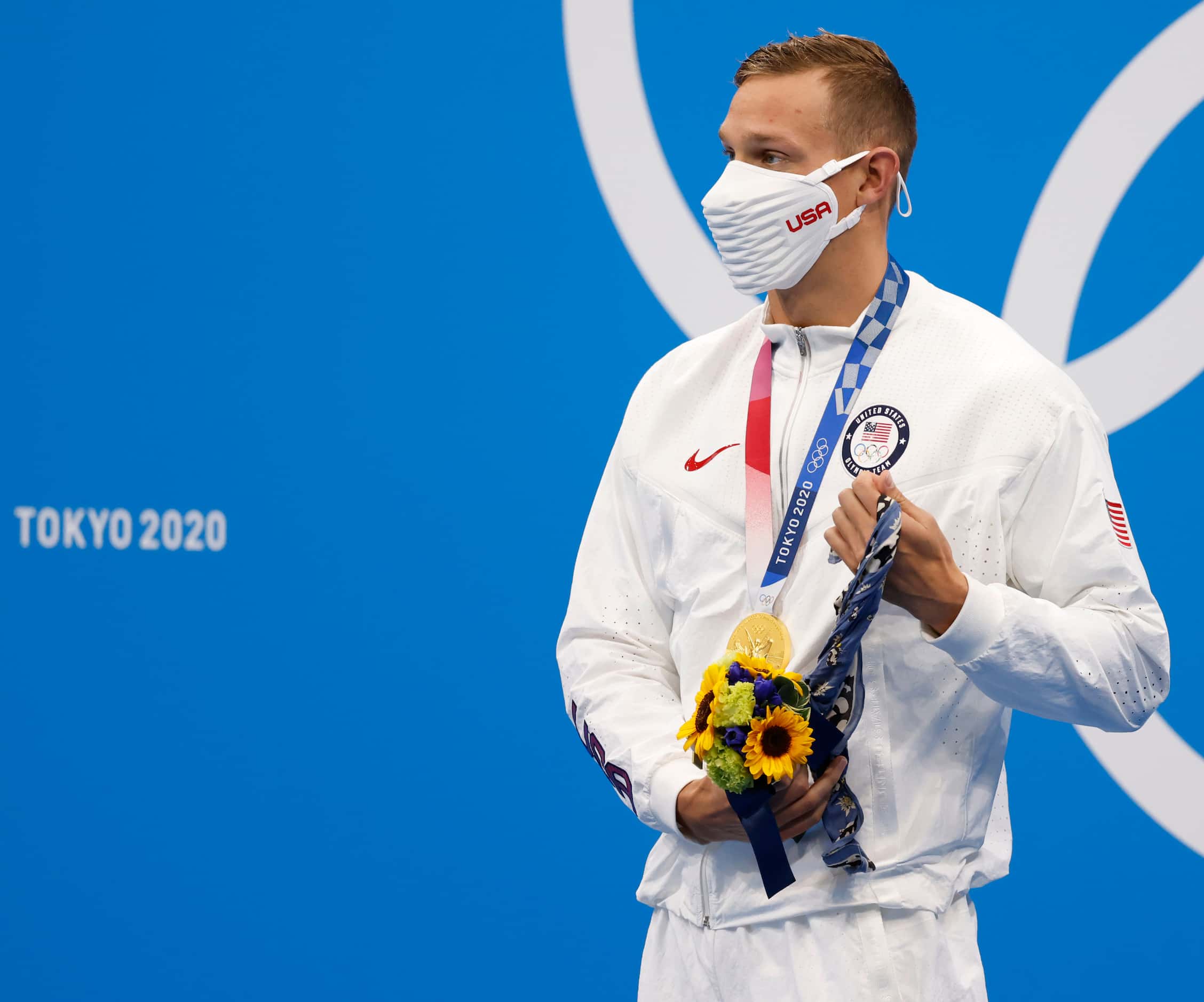 USA’s Caeleb Dressel wraps fabric around his hand after receiving his gold medal during the...