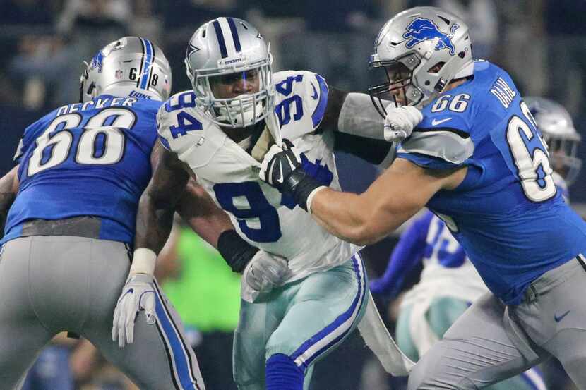 Dallas Cowboys defensive end Randy Gregory (94) tries to fight through the block of Detroit...