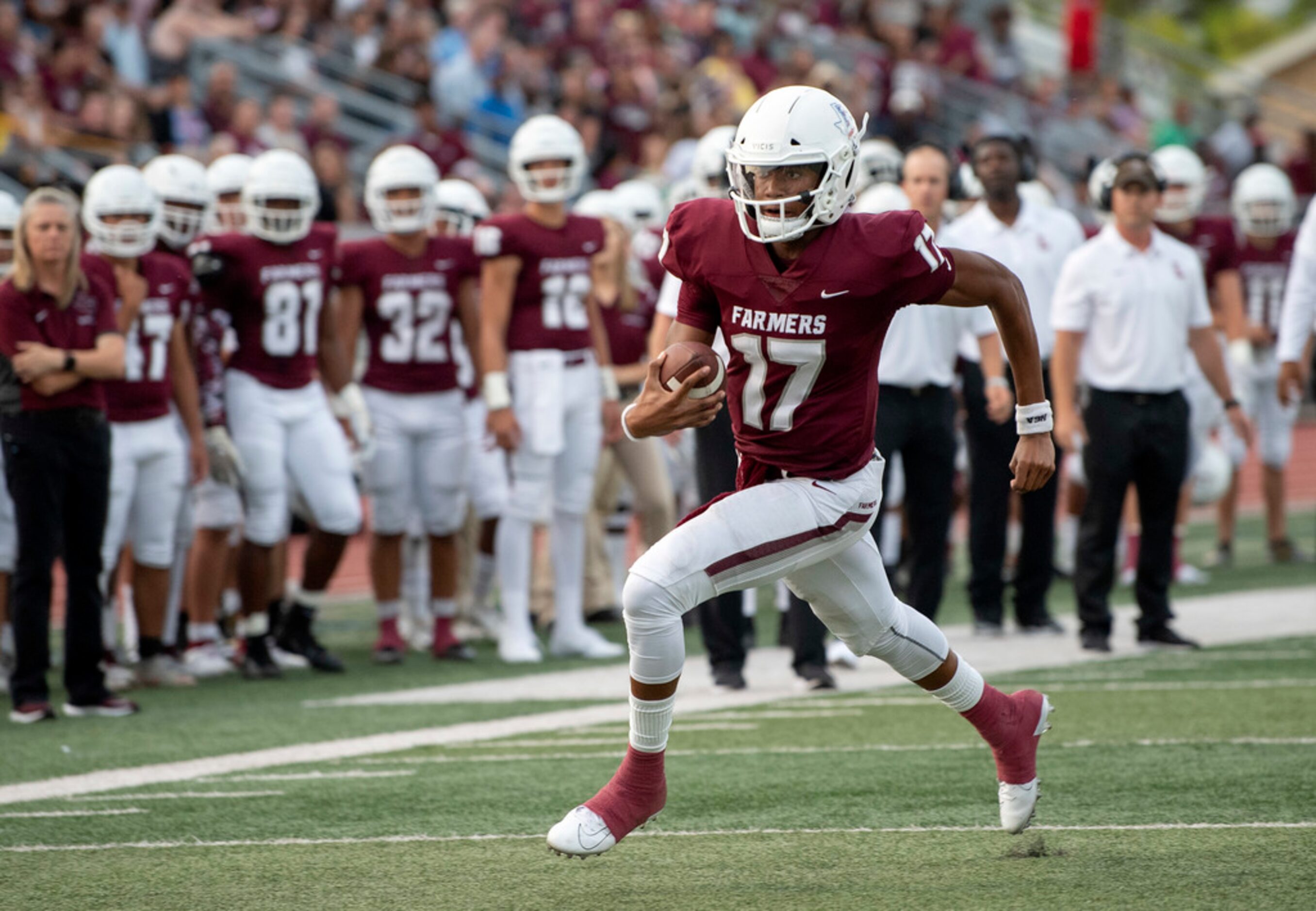 Lewisville junior quarterback Taylen Green (17) carries the ball upfield in the first half...