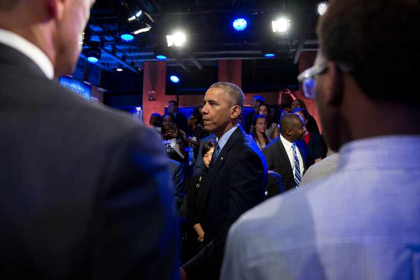 President Barack Obama greets people in the audience after participating in a town hall with...