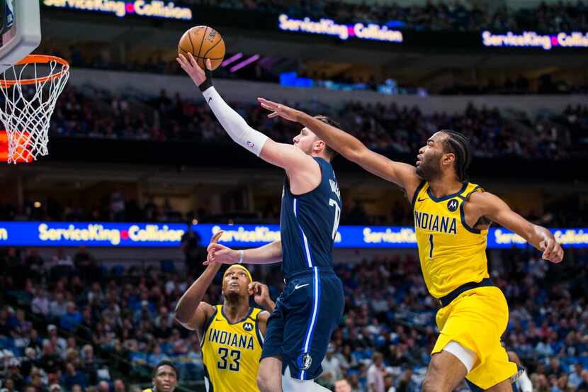 Dallas Mavericks guard Luka Doncic (77) goes up for a shot against Indiana Pacers forward...