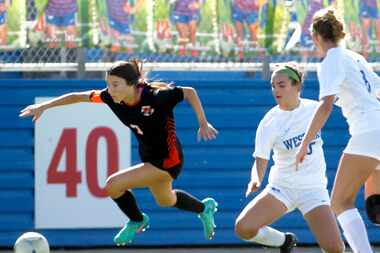 Rockwall defenseman Brinlee Weir (7), left, is tripped by Westlake midfielder Margaret...