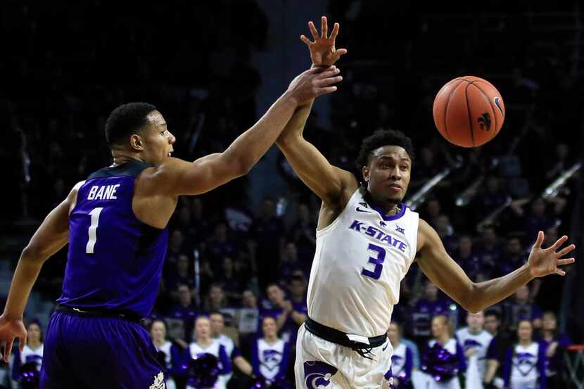 Kansas State guard Kamau Stokes (3) gets the ball to a teammate while covered by TCU guard...