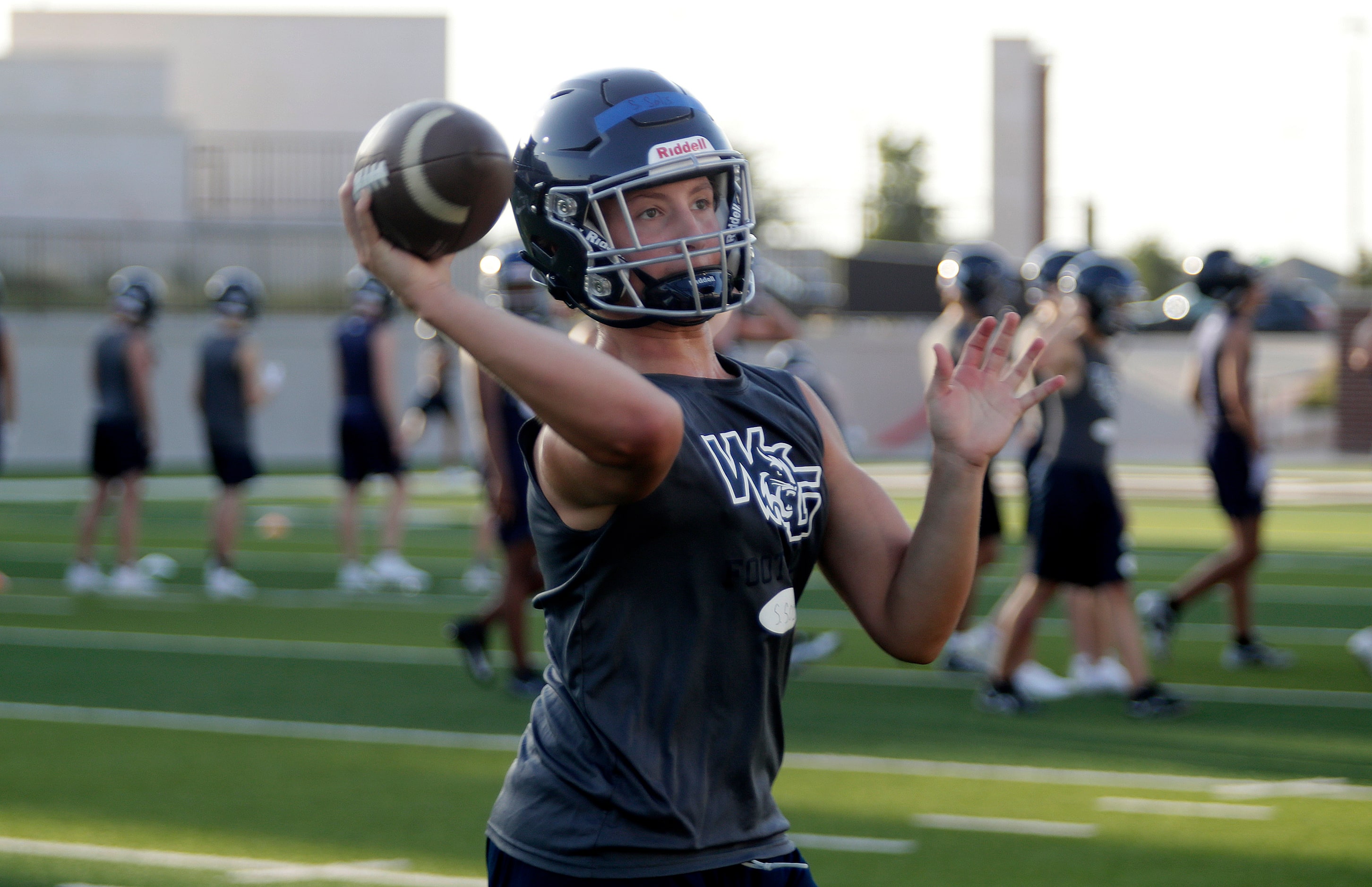 Quarterback Sebastian Solis, 15, throws a pass as Walnut Grove High School held their first...