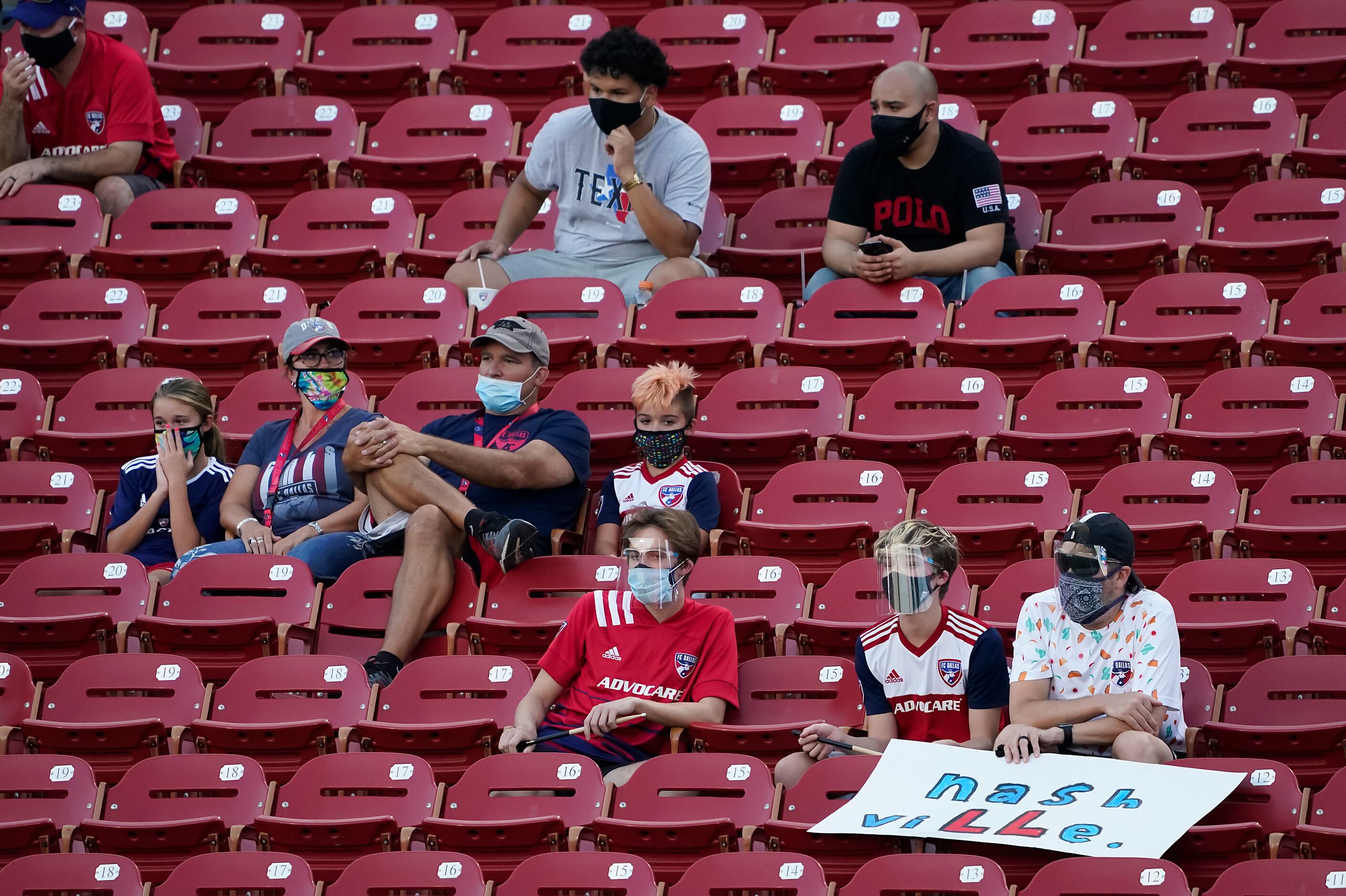 Socially distant fans watch FC Dallas during the first half of an MLS soccer game against...