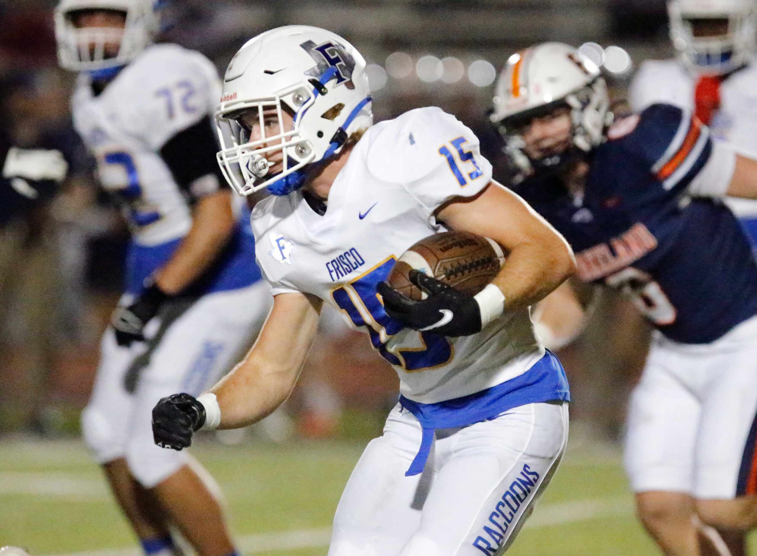 Frisco High School running back Jake Denton (15) looks for room to run during the first half...