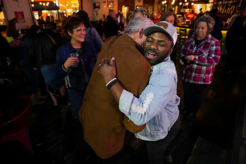 Tae Lewis, a current contestant on The Voice, gets a hug as greets the audience after a...