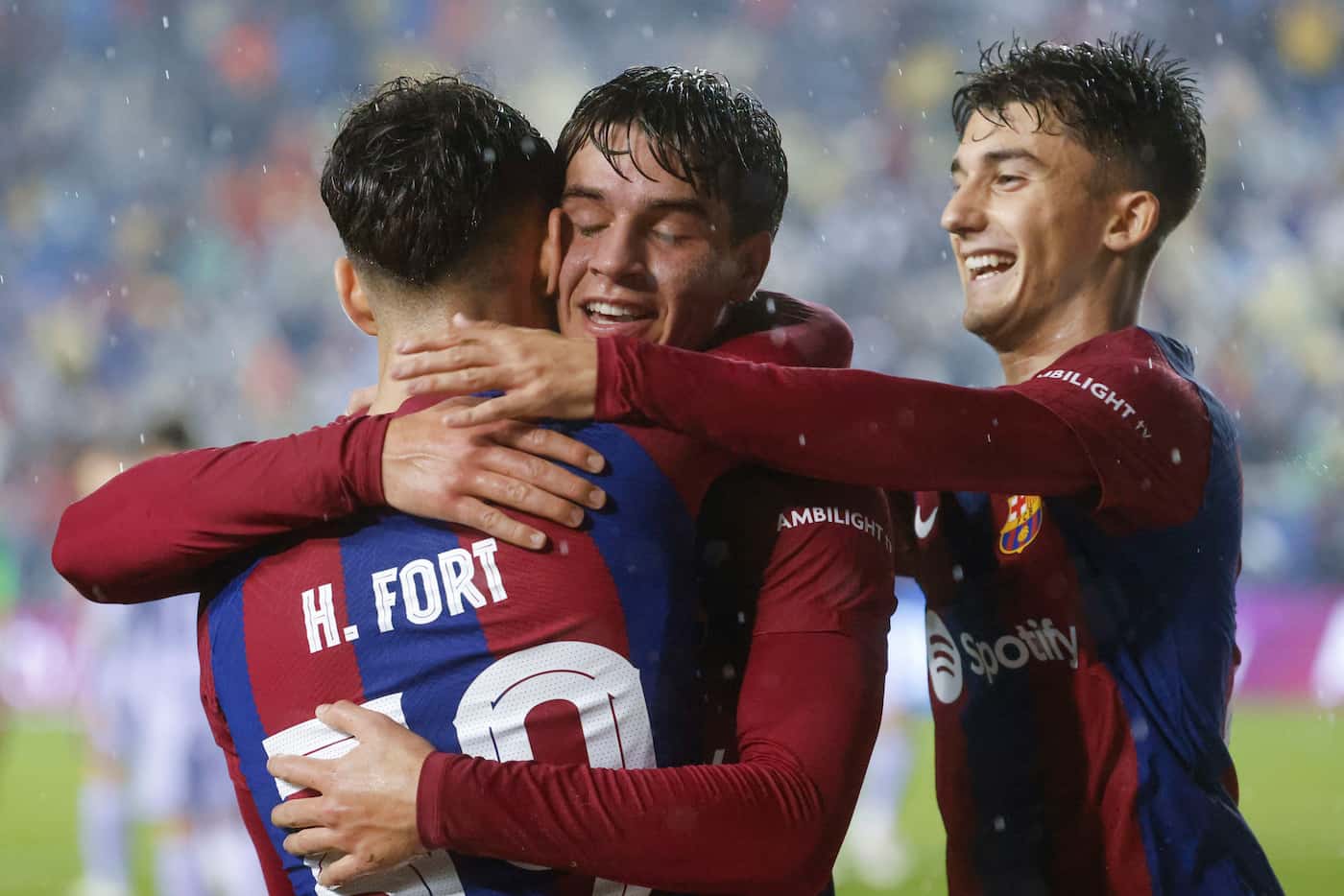 Barcelona’s Hector Fort celebrates after scoring a goal with forward Marc Guiv (center), and...
