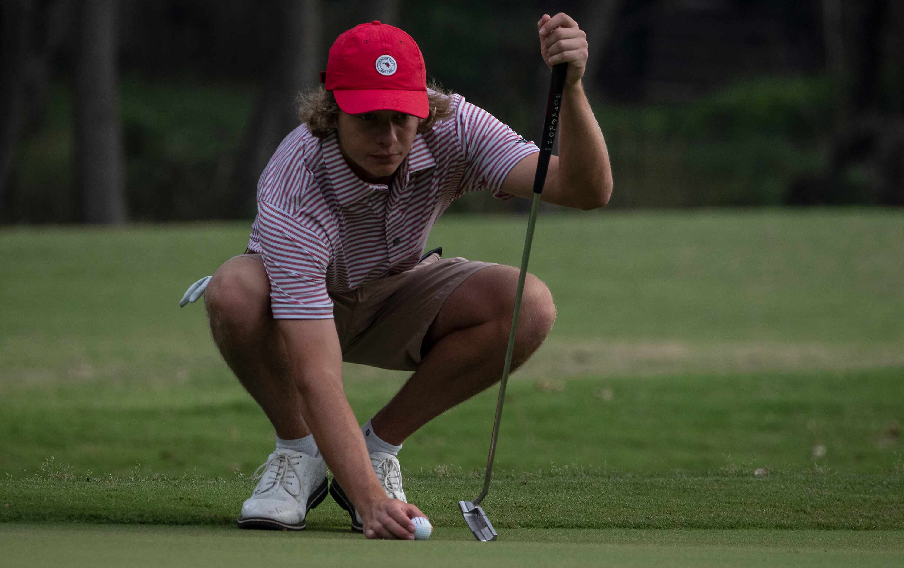 Flower Mound Marcus, Sam Pampling, lines up a putt on the no1. green during the first round...