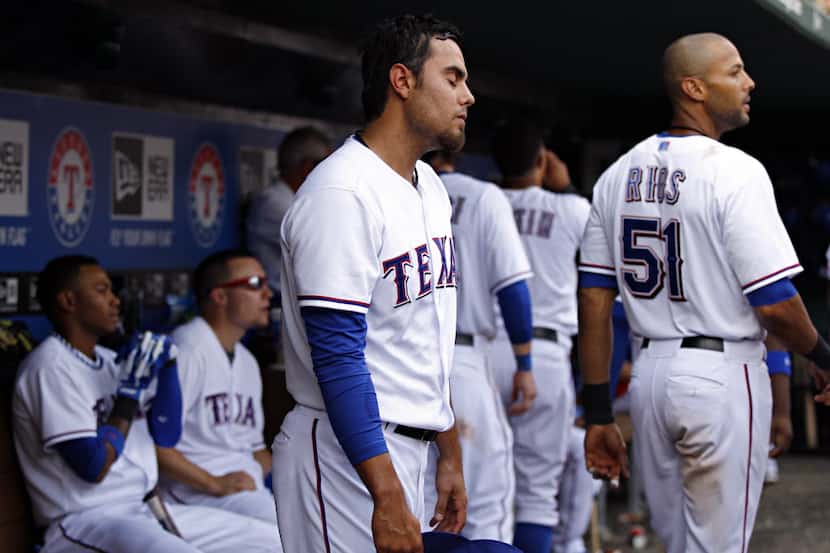Texas Rangers relief pitcher Joakim Soria (center) and other players react near the end of...