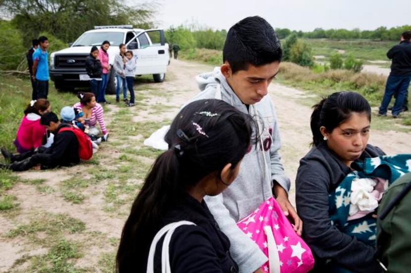
U.S. Border Patrol  agents detain young migrants from Honduras and Guatemala near the...