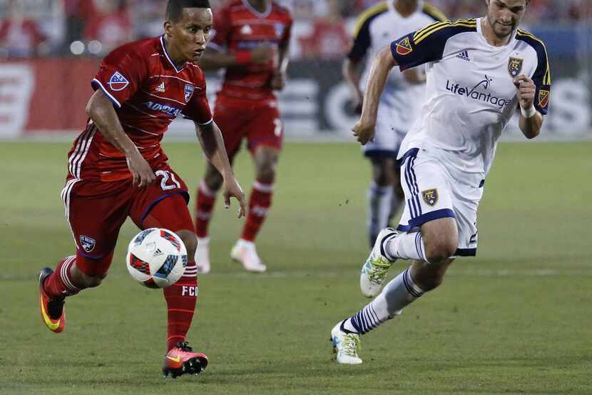 FC Dallas midfielder Michael Barrios (21) takes the soccer ball past Real Salt Lake defender...