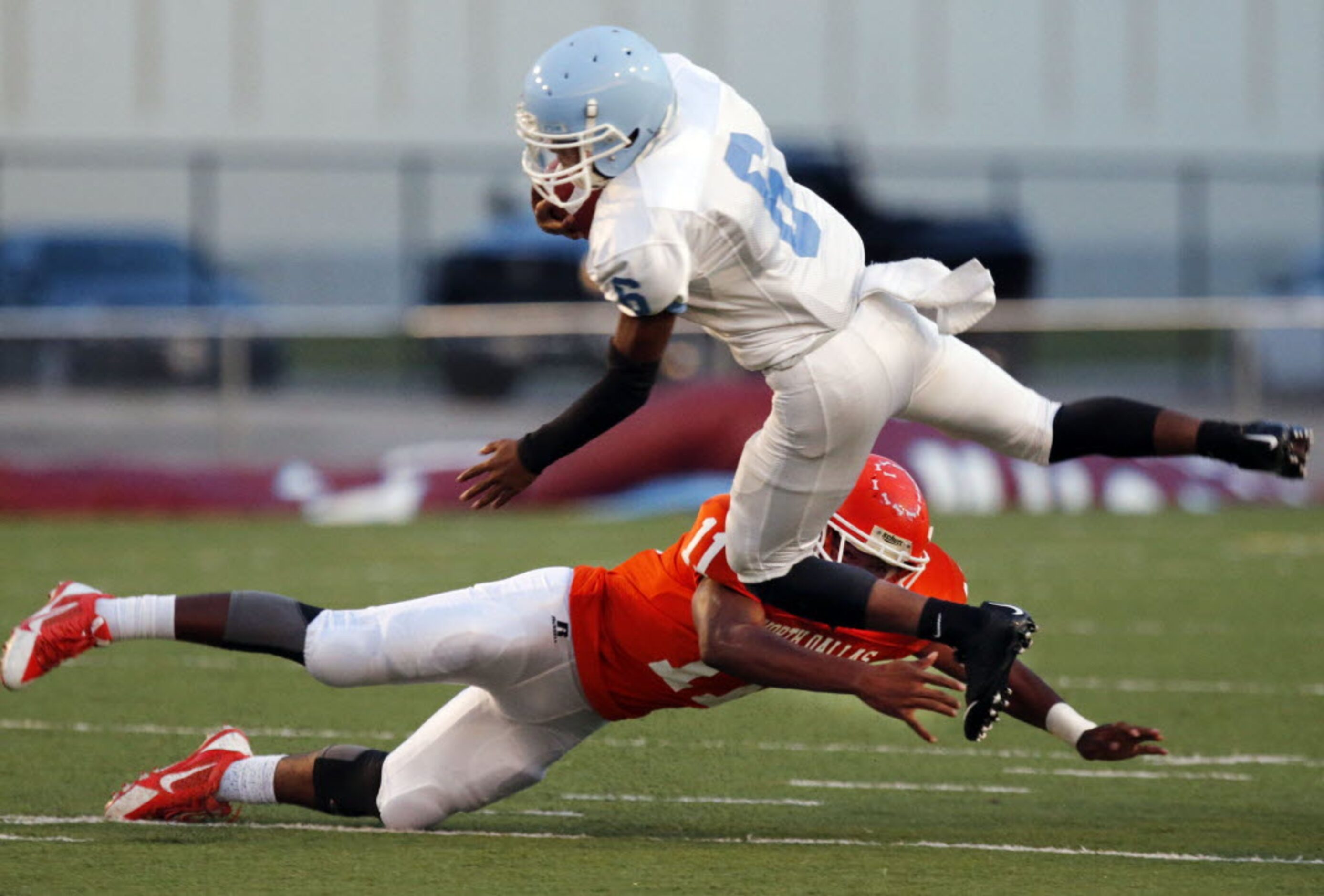 (TXHSFB) Roosevelt High WR Joshua Johnson (6) flies through the air, as he is hit by North...